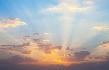 Naklejka na ściany i meble Sunrise with clouds illuminated by the rays of the sun.