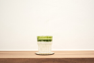 Homemade matcha and milk iced latte on brown wooden table