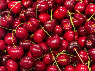 Fresh ripe cherries piled on the market. Food background. Harvest