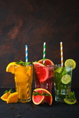 Three classic cocktail glasses on stone black table