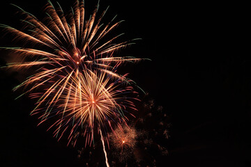 Obraz premium Fireworks. Beautiful display of colorful fireworks on a night sky background.Light abstract