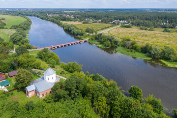 Aerial view of Assumption church (Uspenskaya church, 1749) and pontoon bridge over Moscow river at sunny day. Cherkizovo, Moscow Oblast, Russia.