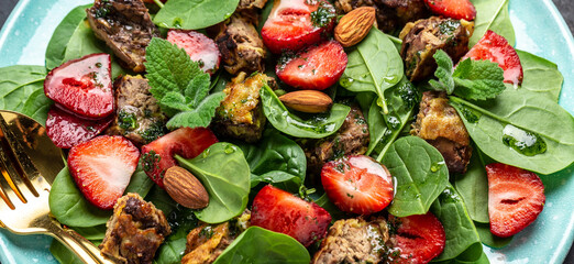 Spinach salad with strawberries, chicken liver, almond and mint. Healthy balanced food. Top view, above, banner