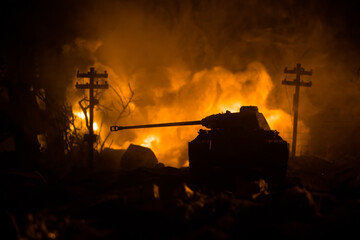 War Concept. Military silhouettes fighting scene on war fog sky background, World War Soldiers Silhouette Below Cloudy Skyline At night. Battle in ruined city. Selective focus