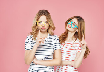 two cute girlfriends in colorful glasses striped t-shirts fashion fun