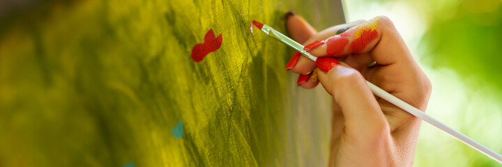 Female artist working on an art canvas painting outdoors in her garden. Mindfulness, art therapy,...