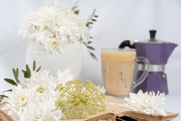 Fototapeta na wymiar Still life with an old book, a cup of coffee and chrysanthemum flowers