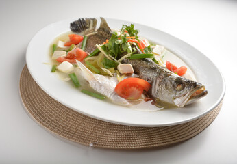 steamed fresh whole grouper fish with beancurd, tomato, sour vegetable and ginger in teo chew style asian halal menu