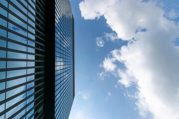 Fototapeta na wymiar Companies buildings. Finance corporate architecture city in abstract blue sky with nature cloud in sunny day. Modern office business building with glass, steel facade exterior.