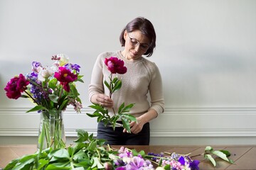 Mature woman at home with spring flowers