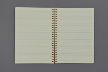 Blank open notebook on grey background with copy space.