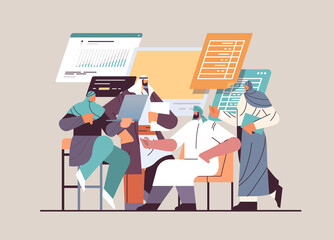 arabic businesspeople analyzing financial data on charts and graphs planning report market analysis accounting