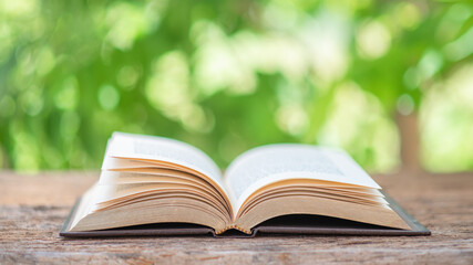 Open book outdoor. Selective focus.Opened book on bright background.