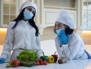 Two friends cooking together. Women friends cooking
