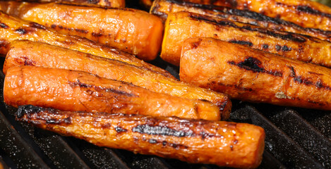 Cooking new carrots in charcoal grill