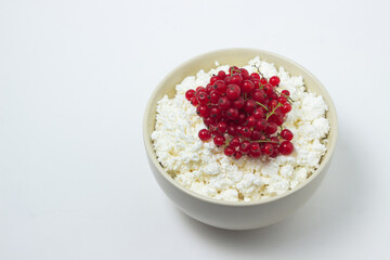 Fototapeta na wymiar Cottage cheese with red currants on a white plate. Delicious and healthy breakfast. Proper nutrition