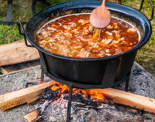 Romanian traditional food prepared at the cauldron on the open fire