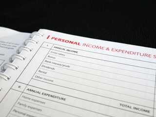 Obraz premium Selected focused on Personal Income and Expenditure text found on one page of a notebook. Be the title to a table of personal income entries that are still empty.