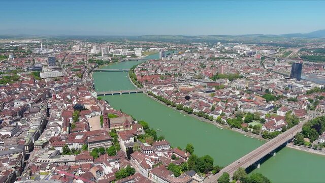 Basel: Aerial view of city in Switzerland at border with France and Germany, cathedral Basel Minster and knee of river Rhine in center of city, clear blue sky - landscape panorama of Europe from above
