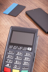 Payment terminal, credit card and smartphone. Cashless paying for shopping. Finance concept