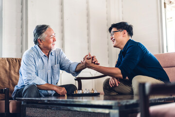 Portrait of happy love asian family senior mature father and young adult son play and looking...