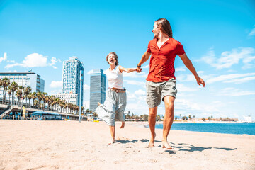 Happy couple in love enjoying vacation running on tropical beach - Boyfriend and girlfriend having...