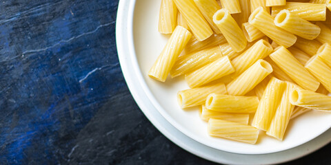 pasta is ready to eat macaroni ziti or penne main course italian cuisine on the table healthy food meal snack copy space food background rustic. top view
