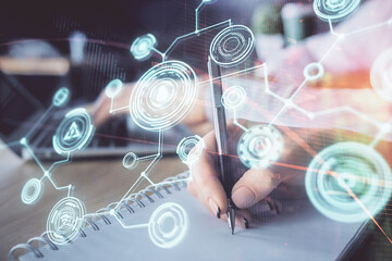 Double exposure of social network theme drawing over people taking notes background. Concept of human connection