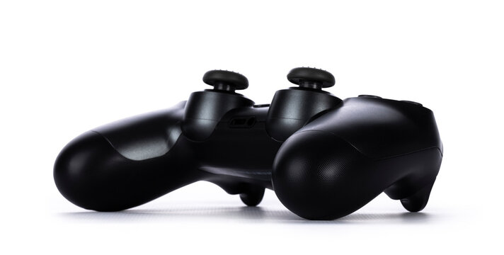 Black game console, laying down. Isolated on white background.