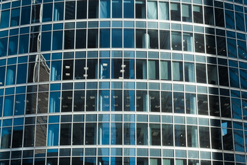 Plakat Modern office building exterior. Close-up facade of a skyscraper, blue windows. Business and finance concept