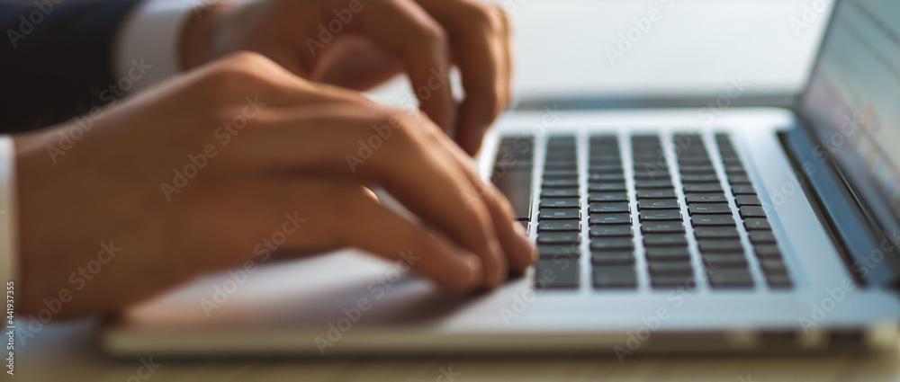 Wall mural The hands typing on the laptop keyboard