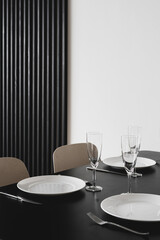 Black kitchen table with dishware and cutlery