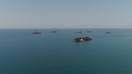 aerial view barges full coal anchored at sea near coal fired power station waiting be transported. coal barges and tugboats java, paiton indonesia