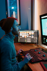 Attractive Male Video Editor Works with Footage or Video on His Personal Computer, he Works in...