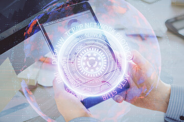 Double exposure of man's hands holding and using a digital device and tech theme hologram drawing. Technology concept.