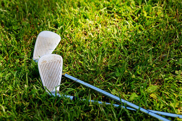 view of two golf clubs on grass - 441938949