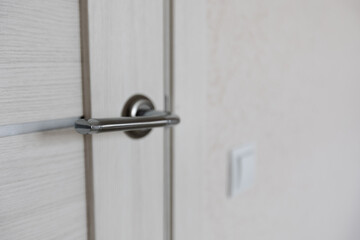 New interior doors close-up. the handle on the door is silver. the concept of renovation and design of the apartment