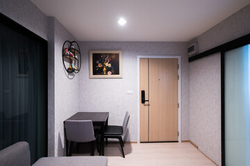 Interior of living room with comfortable sofa and dining table in contemporary apartment.