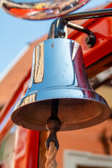 Alarm bell on old fire truck with reflections