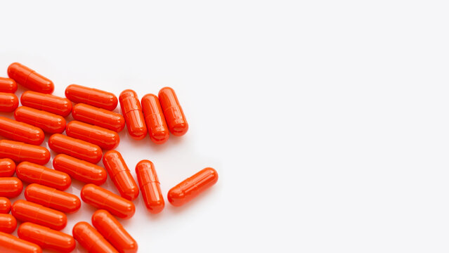 Orange Capsule Pills On White Background.