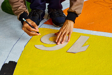 person writing on a playground surface by pencil