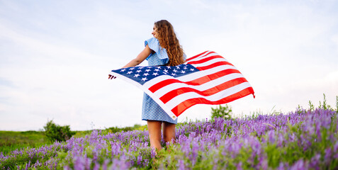 4th of July. Fourth of July. Woman  with the national flag. American Flag. Independence Day. Patriotic holiday. 