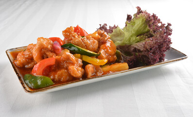 popular chef cook fried sweet and sour chicken with vegetables serve with steam white rice asian halal menu