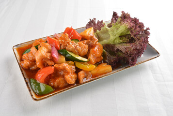 popular chef cook fried sweet and sour chicken with vegetables serve with steam white rice asian halal menu