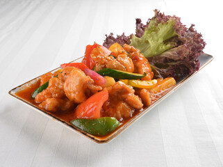 popular chef cook fried sweet and sour chicken with vegetables serve with steam white rice asian halal menu