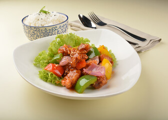 popular chef cook fried sweet and sour chicken with vegetables serve with steam white rice asian halal menu