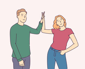 Friendship, partnership and success .Happy man and woman doing high five. Friends greeting or supporting each other.