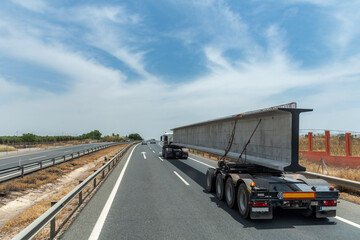 Fototapeta na wymiar Special transport truck with a large beam used for highway bridges,