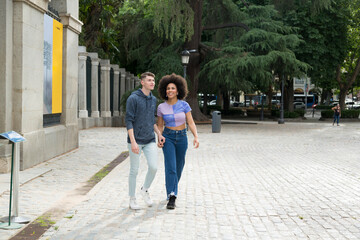 Fototapeta na wymiar Afro girl and Caucasian boy walking