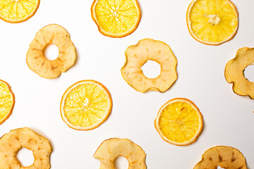 The dry pieces of different fruits in a row to fresh fruits